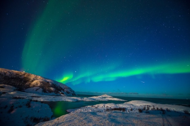Northern lights over a fjord